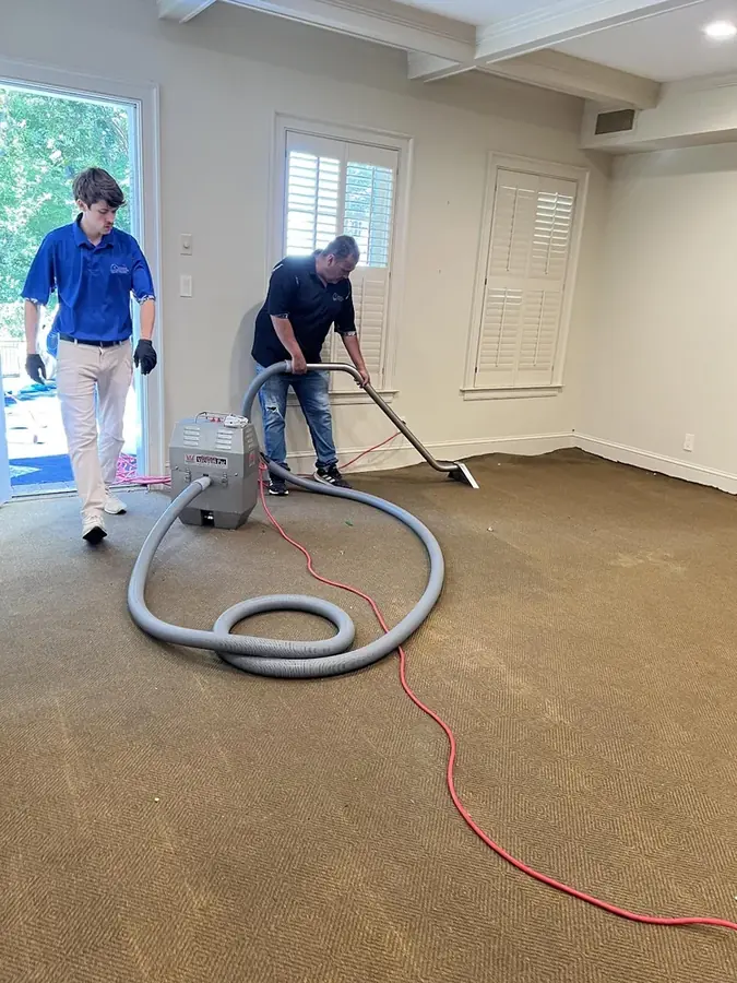 Technicians extracting water from a carpeted room in a Yucaipa, CA home