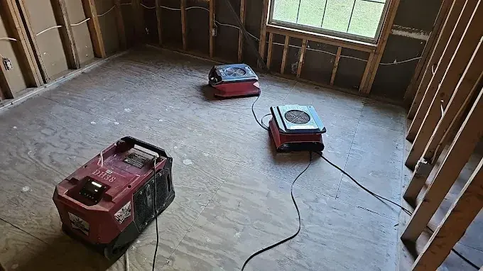 A dehumidifier running in a dried-out room in a Yucaipa, CA home
